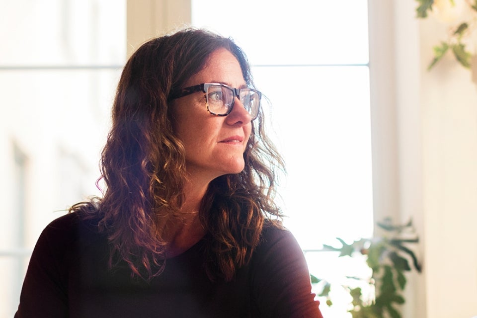 Woman with glasses looking into the distance